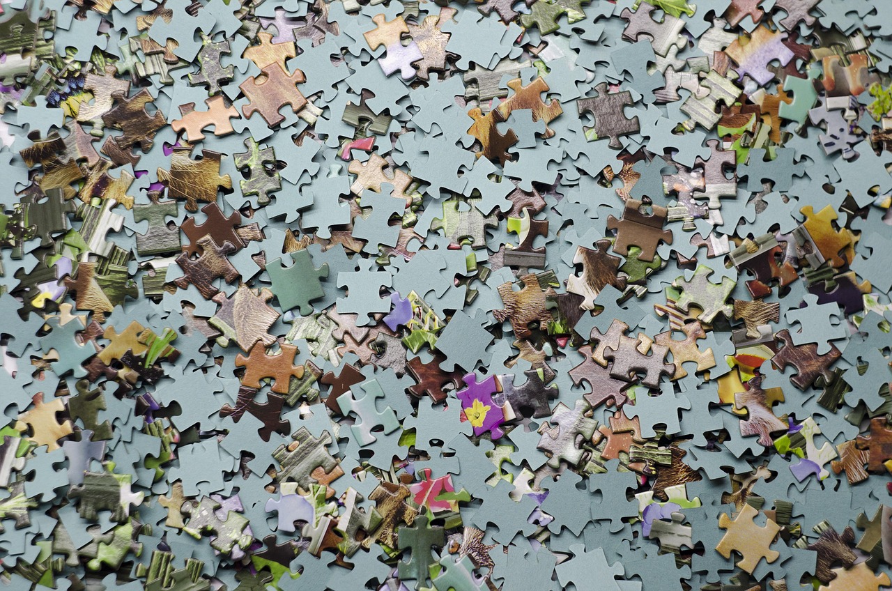 A puzzle being worked on under a desk lamp