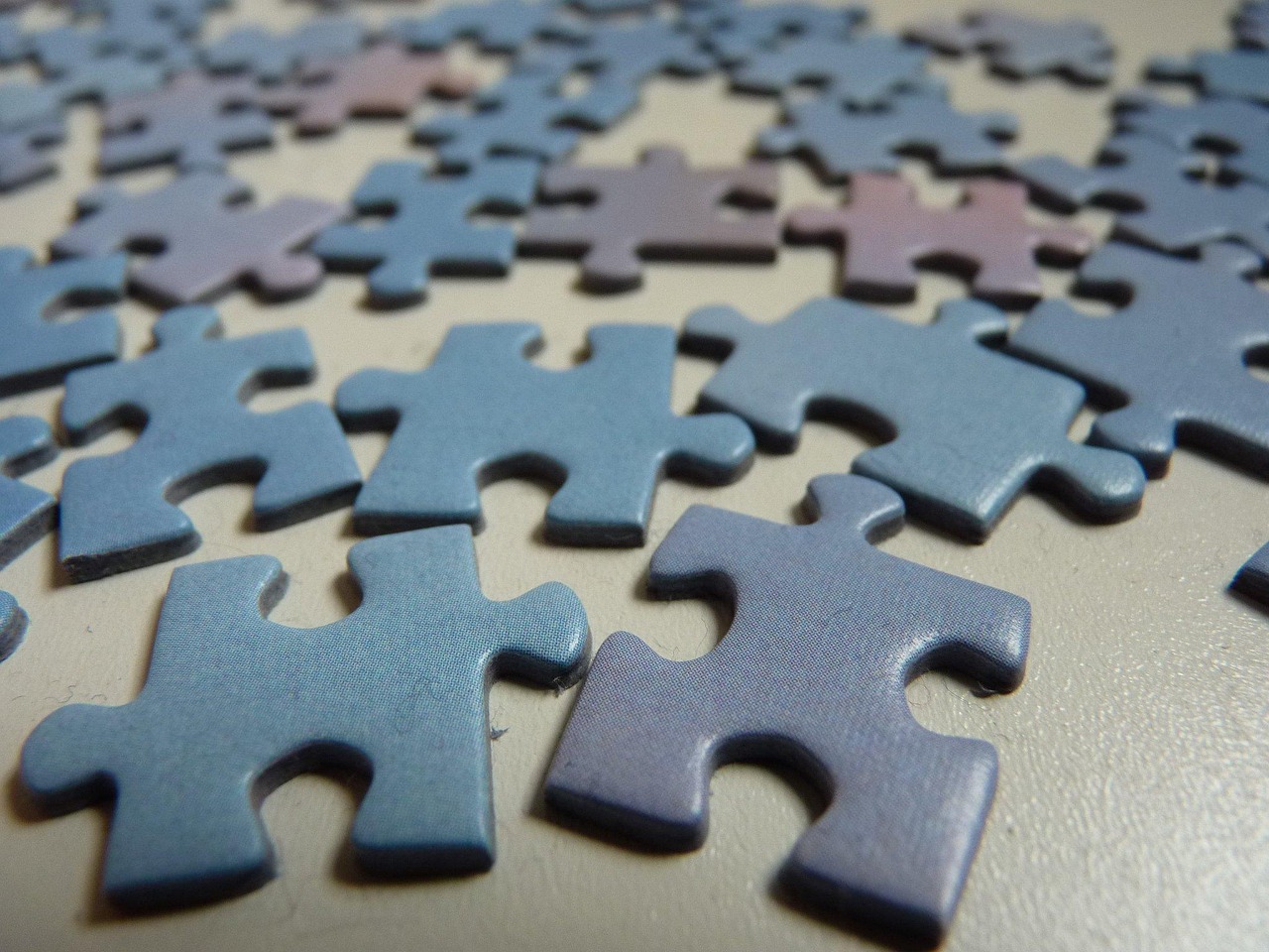 A puzzle board with sorted pieces in shallow trays